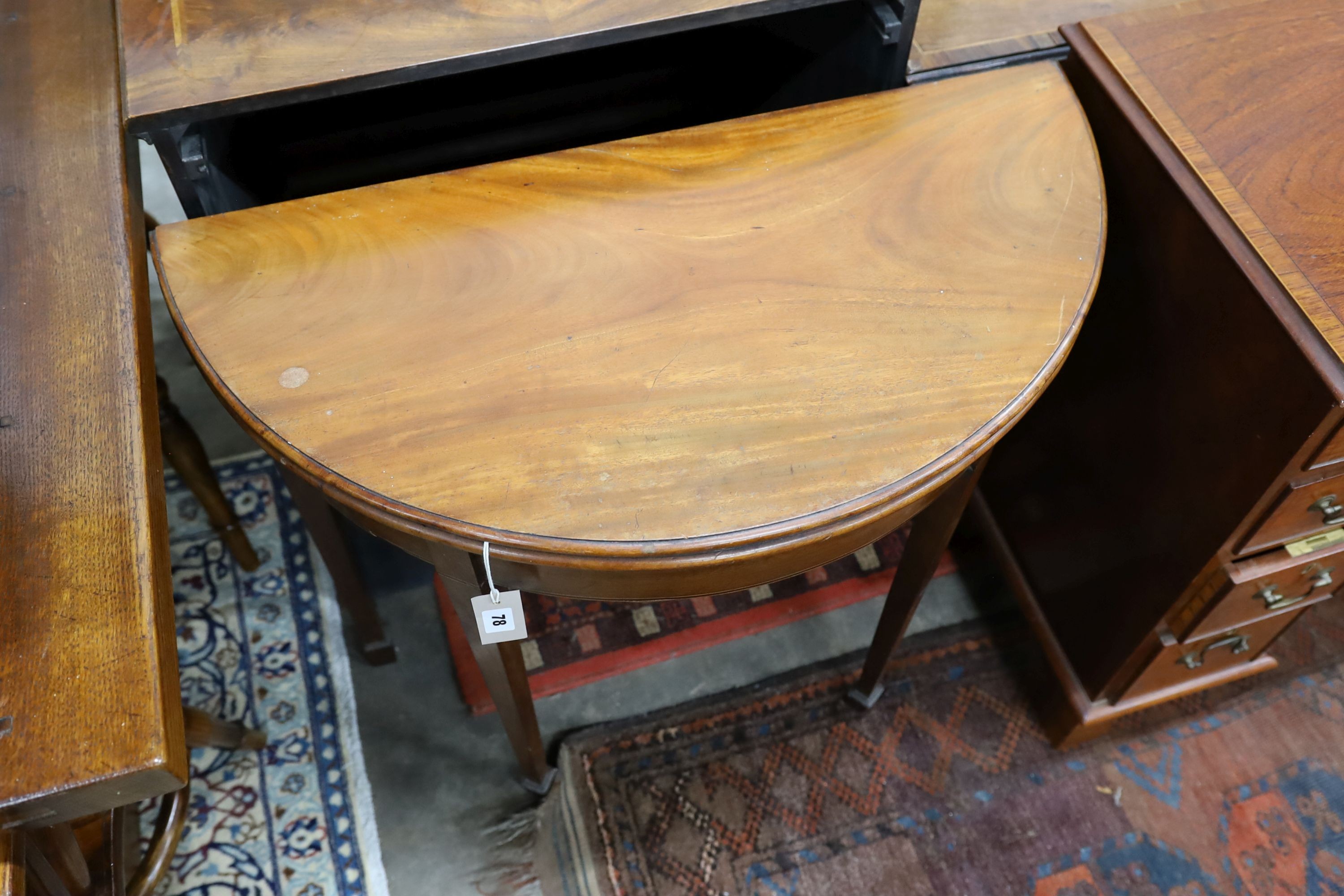 A George III mahogany D-shaped folding tea table, width 39cm, depth 80cm, height 73cm